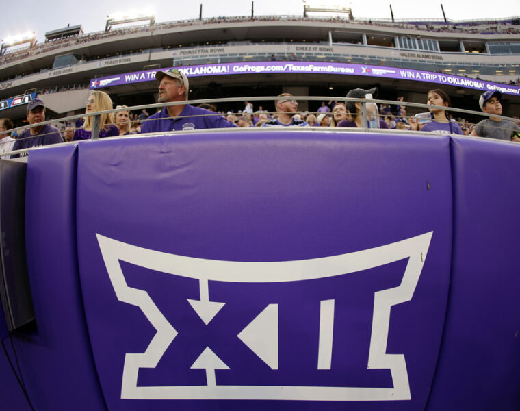 Football stadium with a large Big XII logo featured on a large wall pad